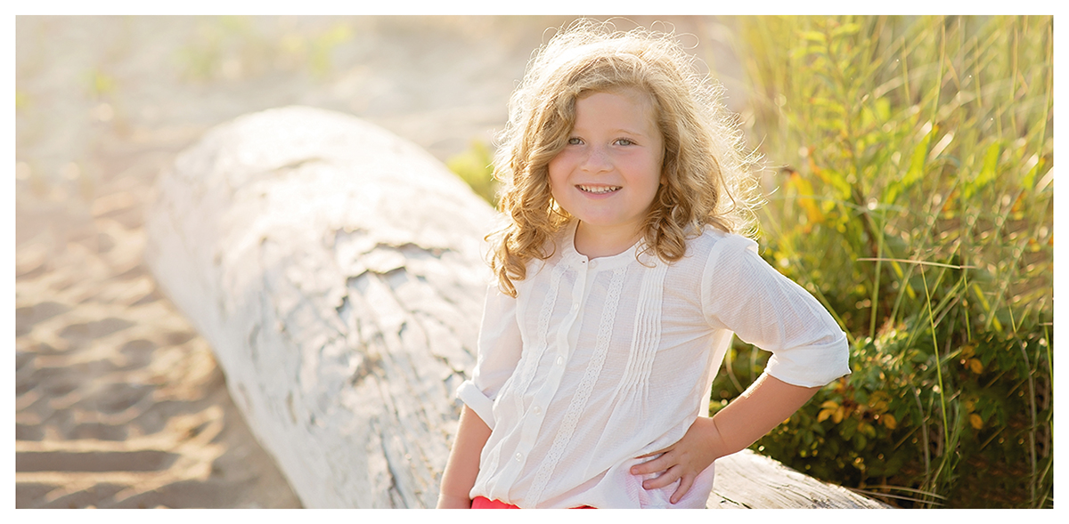 Little girl photographed at Hammanoassett beach in Madison CT by to children's photographer Kelli Dease.