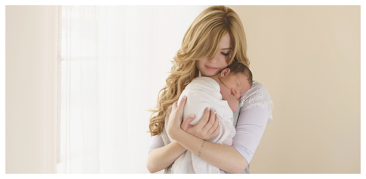Mother holding newborn baby. Newborn photo session in CT photo studio, Kelli Dease Photography.