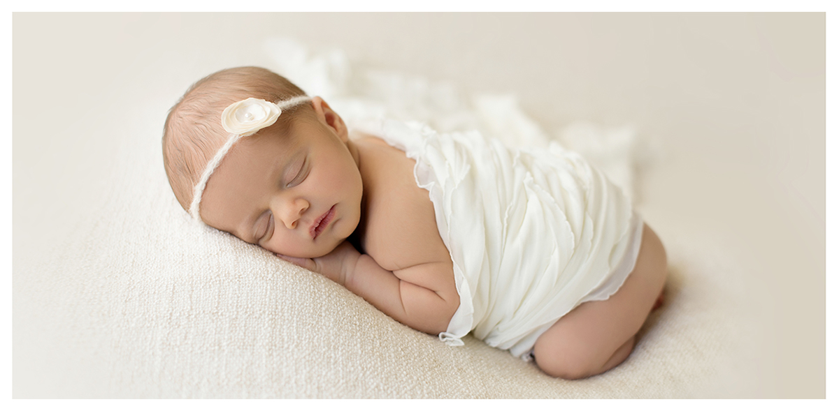 Baby girl on textured cream blanket. Organic newborn photos by Kelli Dease.
