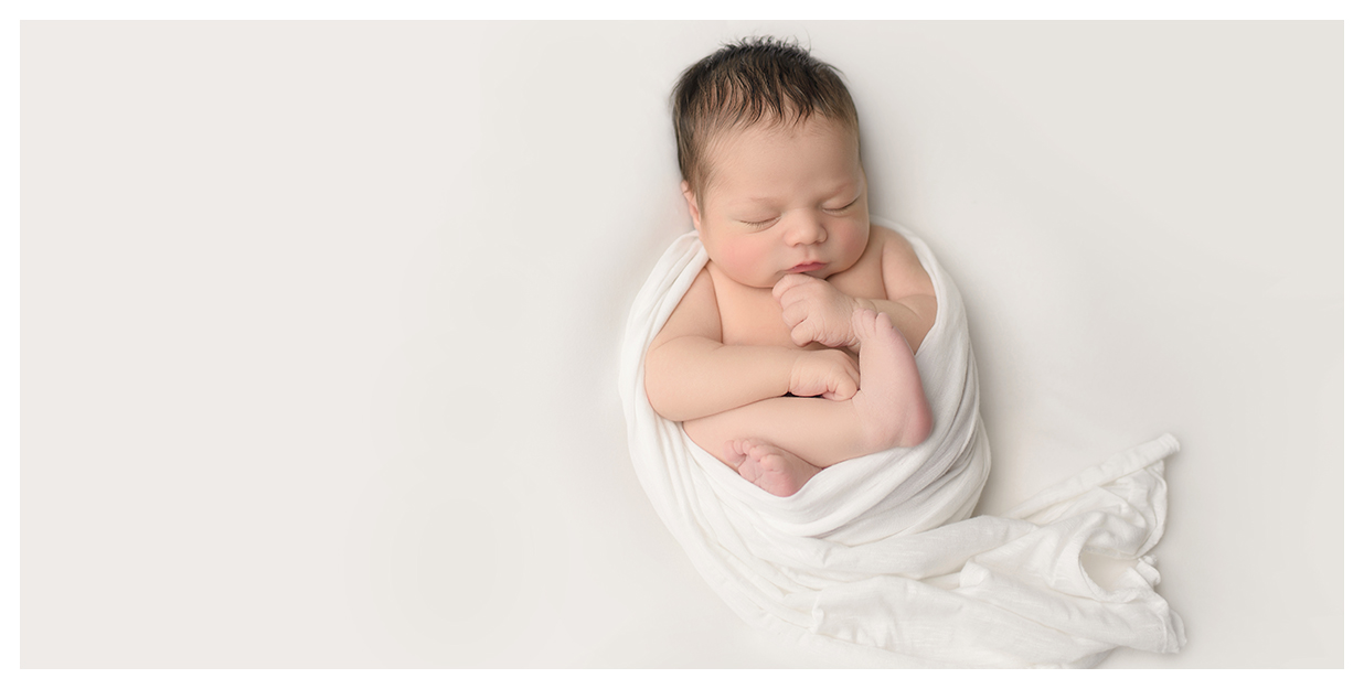 Newborn photo session with simple backgrounds and white blankets. Top CT newborn baby photographer Kelli Dease.