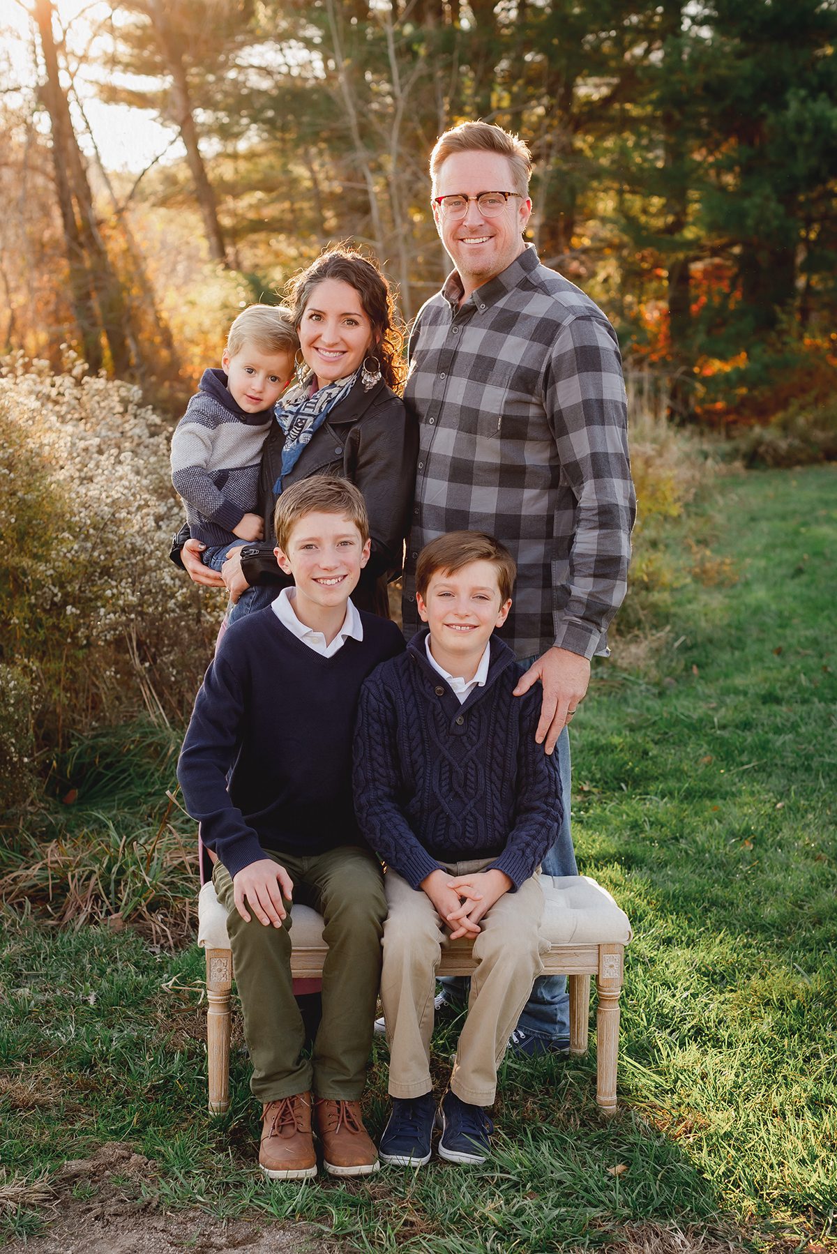Coordinated fall outfits for large family photoshoot in Connecticut woods during peak foliage.