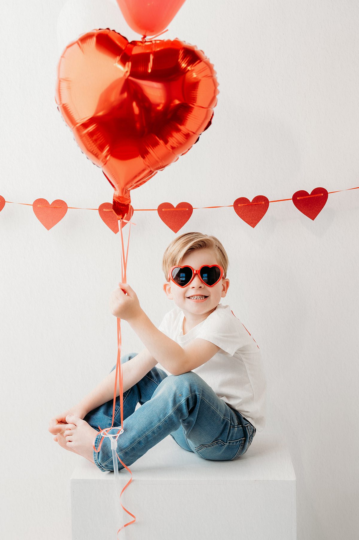 Valentine photo session for kids featuring a 4 year old boy in a bright Connecticut photography studio