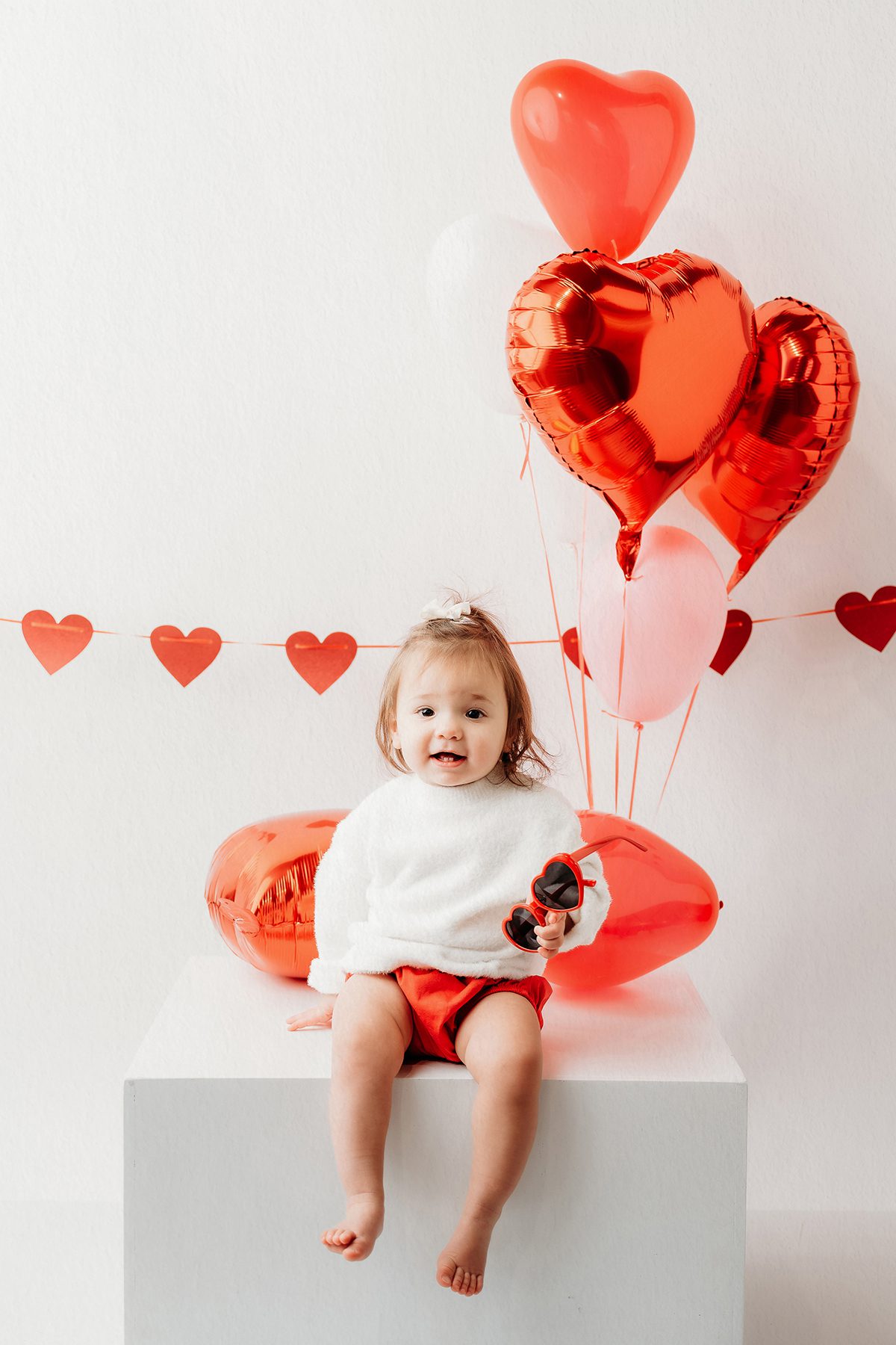 Valentine mini sessions for kids in Connecticut featuring playful, heart-filled portraits in a clean studio setting.