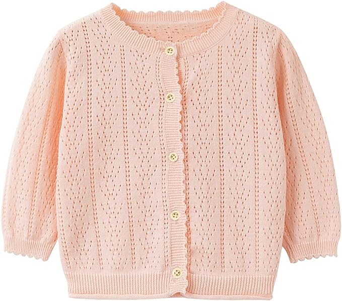 a pink cardigan with buttons for a little girl