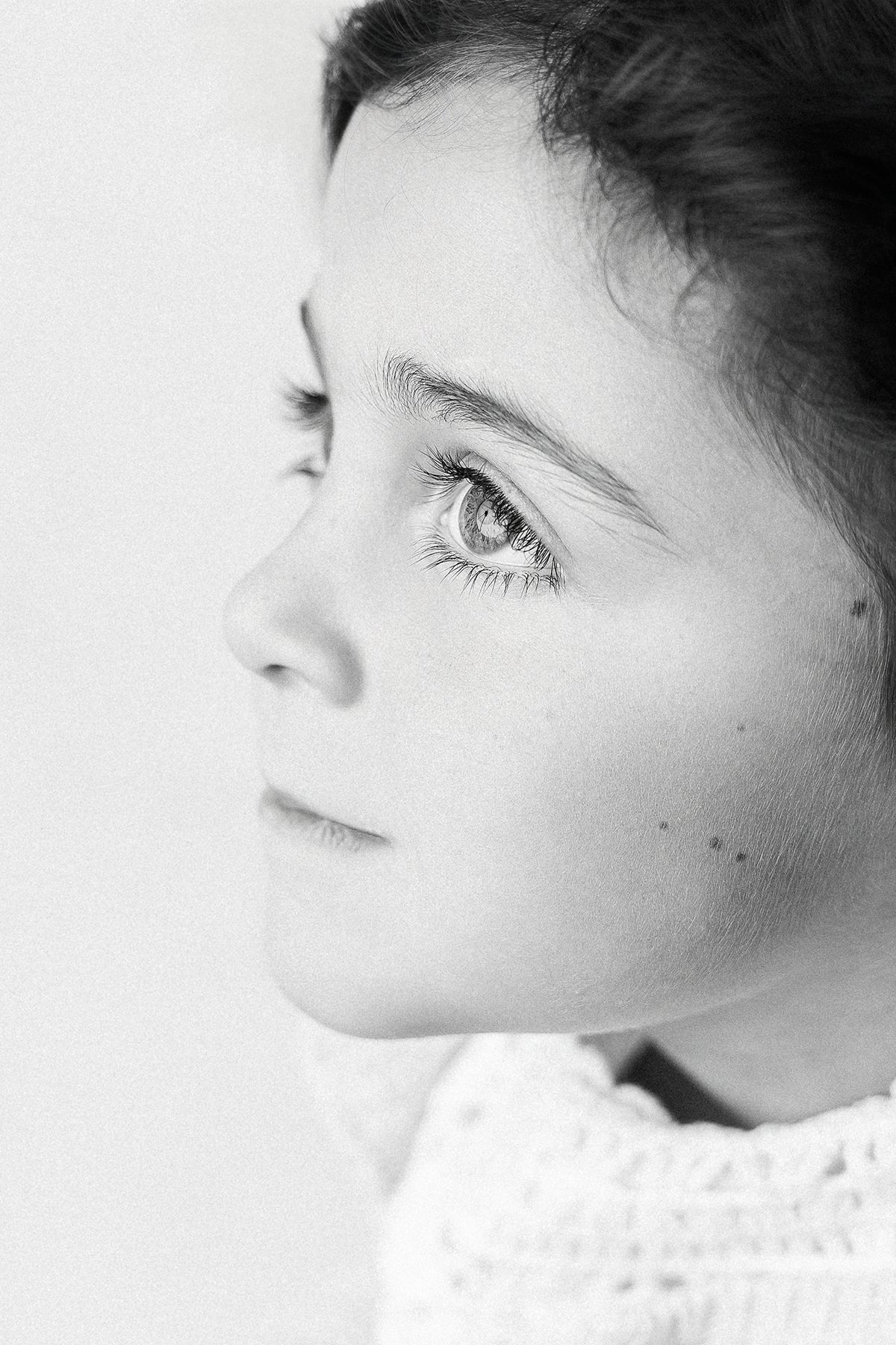 Young girl in profile with soft natural light, lace collar top, Kelli Dease Photography Farmington CT