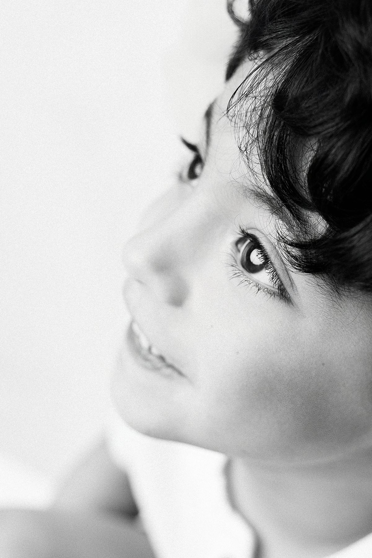 Young boy in profile looking upward, black and white studio portrait, Kelli Dease Photography