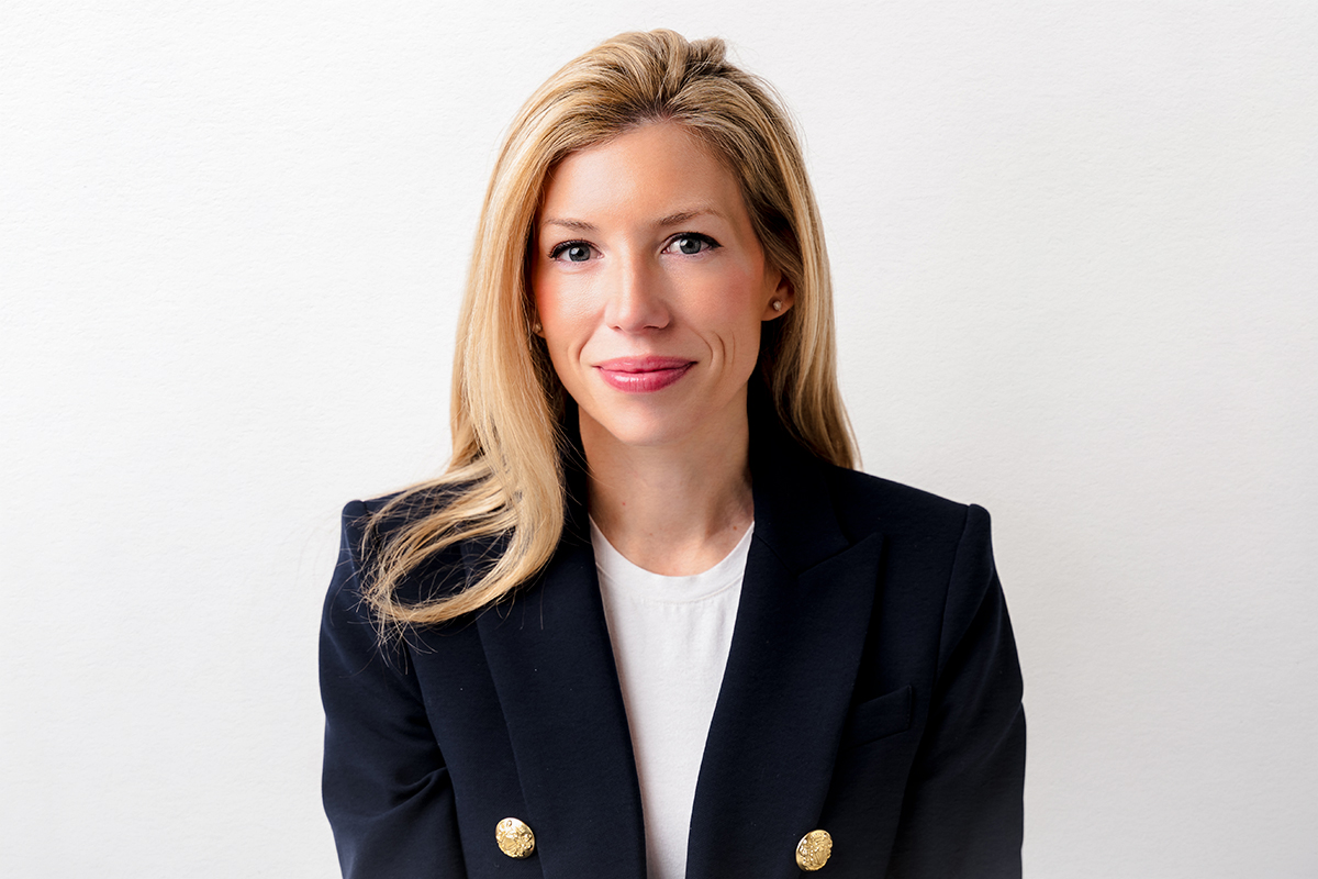 A professional corporate headshot of a blonde woman in a blue blazer, taken in Farmington, Connecticut.